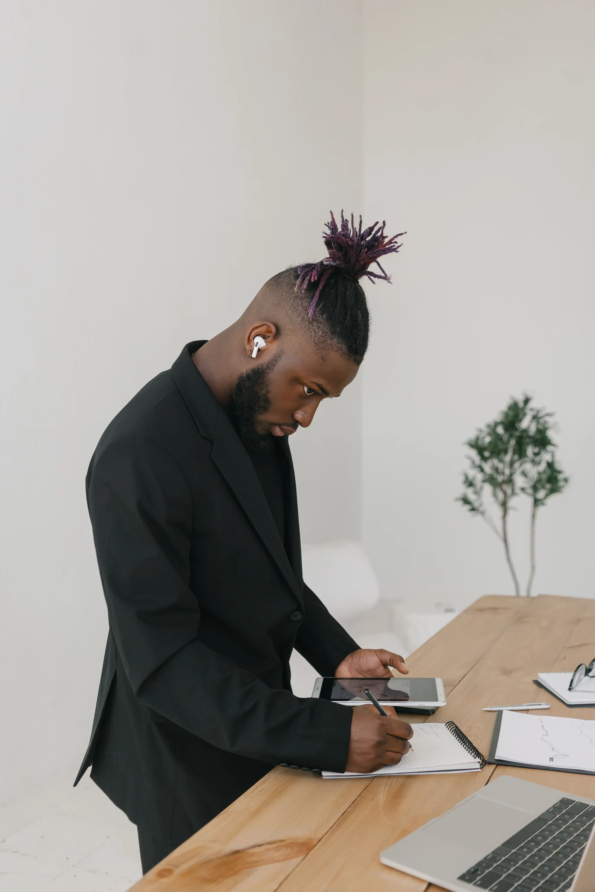 African entrepreneur planning business growth with charts and notes